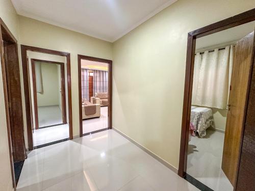 an empty room with a door and a living room at Estrela de Euclides in Euclides da Cunha