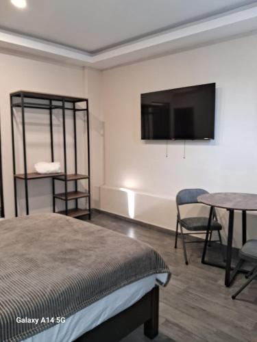 a bedroom with a bed and a table and a tv at La morada Enamorada in Mexico City