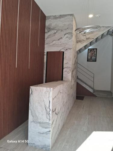 a room with a stone wall with a chair in it at La morada Enamorada in Mexico City
