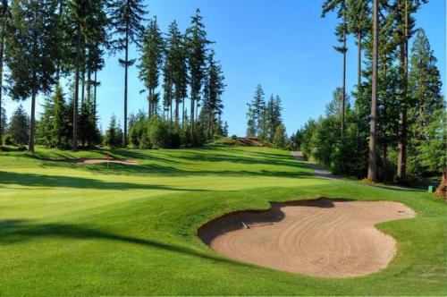 a golf course with a sand bunker on a green at Awesome 2BR in Lynn Valley in North Vancouver