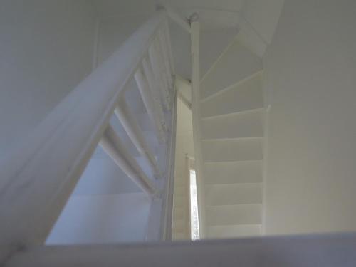 a room with a white wall and a window at La Petite Lili in Dinant