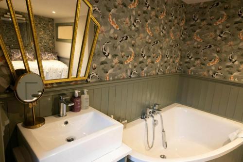 a bathroom with a sink and a mirror and a tub at Private Country Residence Made 4 Luxury Gathering in Newcastle West