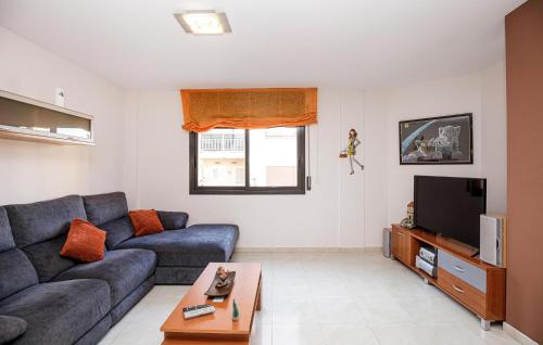 a living room with a couch and a tv at Beautiful Apartment In Pineda De Mar in Pineda de Mar
