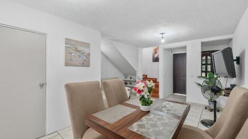 a dining room with a table and chairs and a television at Casa Cozy, 2 bedroom, 4 bed, 2 baths with parking in Puerto Vallarta