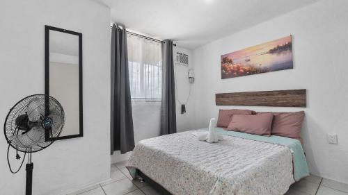 a bedroom with a bed and a fan at Casa Cozy, 2 bedroom, 4 bed, 2 baths with parking in Puerto Vallarta