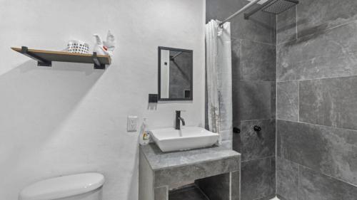 a bathroom with a sink and a toilet and a shower at Casa Cozy, 2 bedroom, 4 bed, 2 baths with parking in Puerto Vallarta