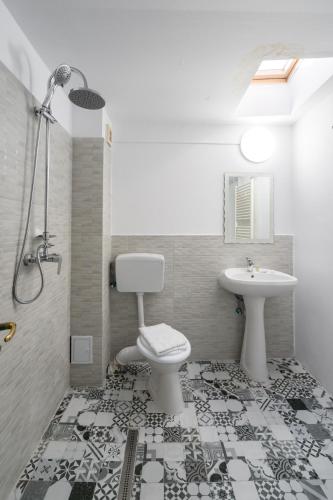 a bathroom with a toilet and a sink at Flowers Grand Hotel Bucharest in Bucharest