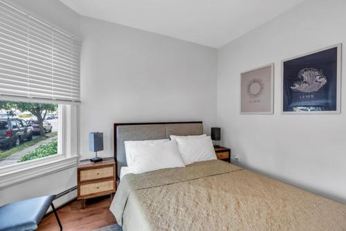 a bedroom with a large bed and a window at The Central Ave House in Ocean Grove