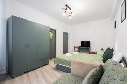 a bedroom with a bed and a couch at Flowers Grand Hotel Bucharest in Bucharest