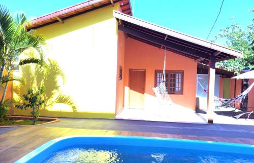 a house with a swimming pool in front of it at Temporada Belas Casas in São Pedro