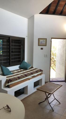 a room with a bed and a table and a chair at Cabaña Tala Huasi in Villa Icho Cruz