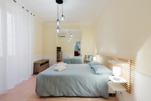a bedroom with a bed and a bath room at Casetta Fardella 95 in Trapani