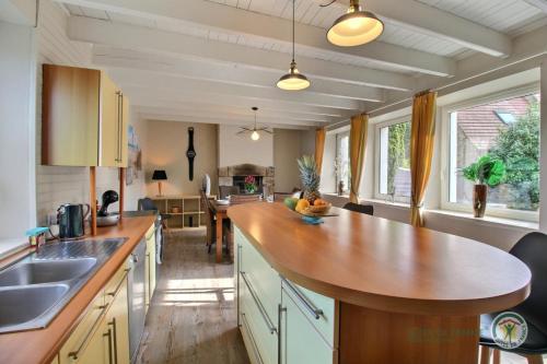 - une cuisine avec un grand comptoir en bois dans l'établissement De la chapelle, à Pleumeur-Bodou