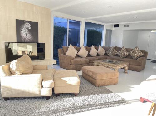 a large living room with couches and a table at Beautiful 4BD and 3BA Pool Jacuzzi Vacation Home in Los Angeles
