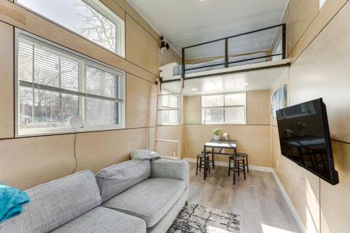 a living room with a couch and a tv at Hiking and Creek Manor Tiny Home in Forest Retreat in Manor