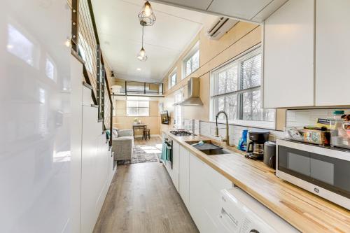 a kitchen with white cabinets and a sink at Hiking and Creek Manor Tiny Home in Forest Retreat in Manor