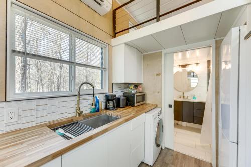 a kitchen with a sink and a window at Hiking and Creek Manor Tiny Home in Forest Retreat in Manor