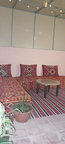 a living room with a couch and a table at Maison pres plus Grand Bazar d'Afrique Souk El Had in Agadir