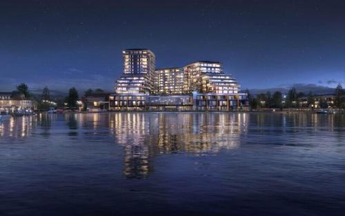 a lit up building on the water at night at Beach Lake Resort in Kelowna