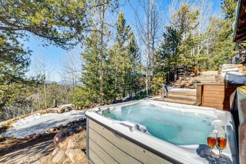 a jacuzzi tub on the side of a house at Private Fishing Pond Mtn-View Home in Florissant! in Florissant
