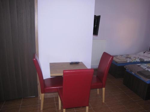 a small table and chairs in a room with a bed at Noclegi Andersa in Wałbrzych