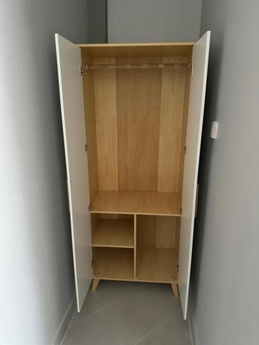 a cupboard in a corner of a room at Eastern City Apartments in Dodoma