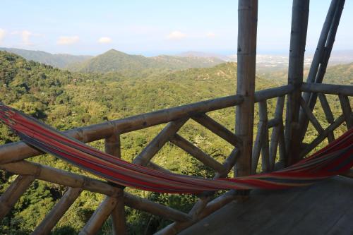 a hammock on top of a mountain with a view at Rancho de la luna in Minca