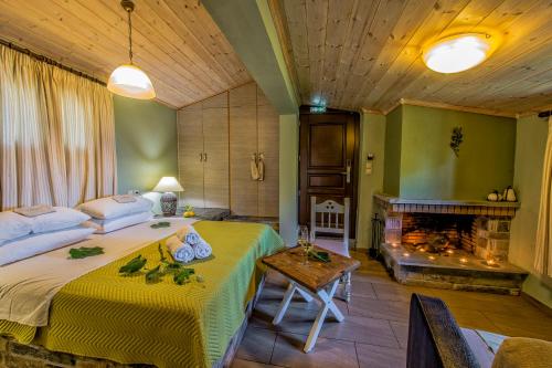 a bedroom with a large bed and a fireplace at Pounda Paou in Metókhion