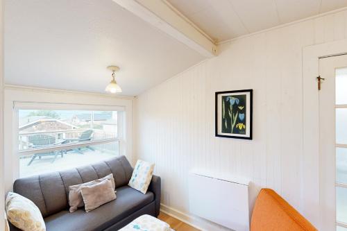 a living room with a couch and a window at Baerfoot Bungalow in Cannon Beach