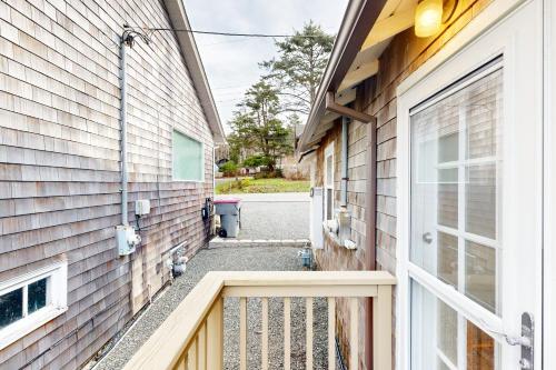 a walkway between two buildings with a gate at Baerfoot Bungalow in Cannon Beach