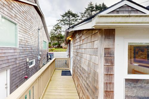 a wooden walkway leading to a house at Baerfoot Bungalow in Cannon Beach