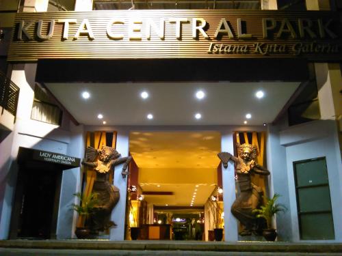 a hotel entrance with a sign that reads la central at Kuta Central Park Hotel in Kuta