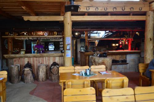 a restaurant with a table and chairs and a bar at Resort Svět in Úžice