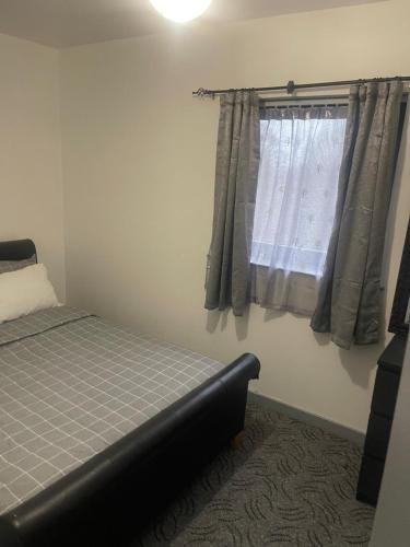 a bedroom with a bed and a window at D'Chin Dorcelle Suite in Norbury