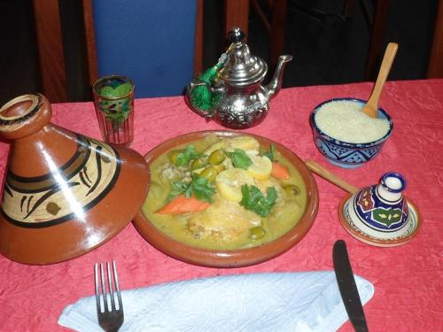 a table with a plate of food on a table at Hôtel Le Hussard in Alençon