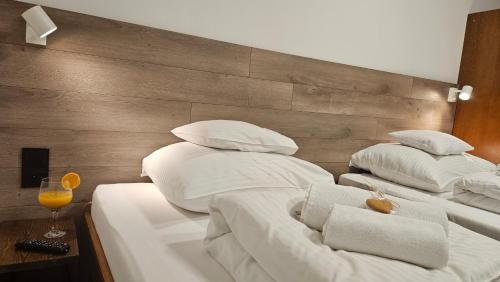 two beds with white sheets and pillows in a room at Hotel Protea Bolesławiec in Bolesławiec
