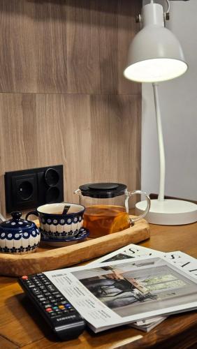a table with a remote control and a plate of food at Hotel Protea Bolesławiec in Bolesławiec