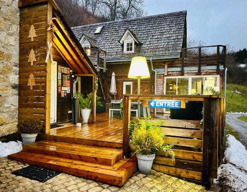a house with a wooden deck in front of it at Le Solayan in Couledoux
