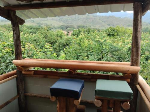 two chairs sitting on a porch with a view of the mountains at Ecohotel la Floresta in Ginebra