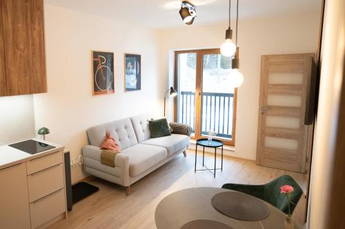 a living room with a couch and a table at Apartmán Dobré Bydlo v Beskydech in Horní Bečva