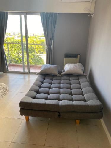 Una cama o camas en una habitación de Terra Monoambiente