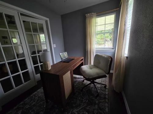 a room with a desk and a chair and a window at Pet Paradise on Main Fenced Yard Included in Calera