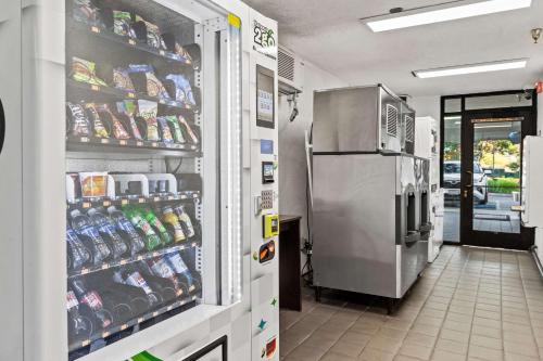 a store aisle with a refrigerator in a store at Motel 6-San Luis Obispo, CA - South in San Luis Obispo