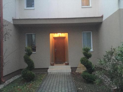 a house with a brown door with a light on it at A2 Apartman in Sopron