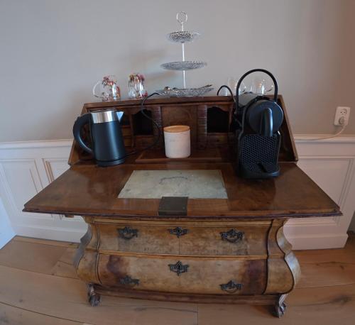 a wooden table with a tea kettle on top of it at Royal Rooms Dordrecht in Dordrecht