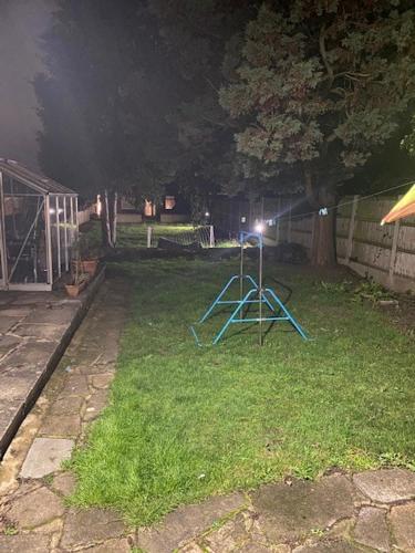 a light in a yard at night at Two Bedrooms Bungalow Garden Lodge in Aveley