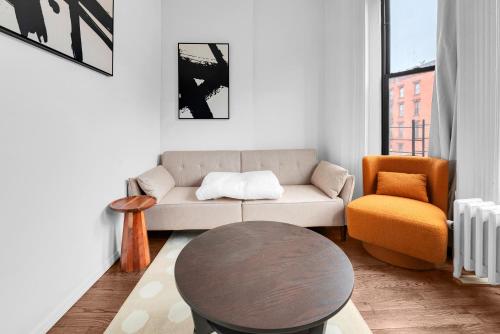 a living room with a couch and a table and a chair at Stylish 3Bd Heart of Park Slope in Brooklyn