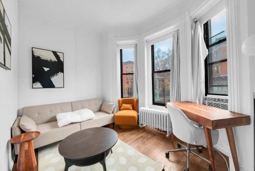 a living room with a couch and a table at Stylish 3Bd Heart of Park Slope in Brooklyn
