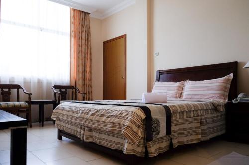 Ένα ή περισσότερα κρεβάτια σε δωμάτιο στο Jeruton Hotel