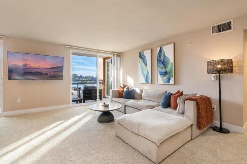 a living room with a couch and a table at The Citrine Suite - Water View Large Condo 2BR Marina in Los Angeles